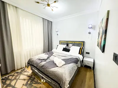 a bedroom with a bed with two towels on it at Dream Apartment in Sheshli 5 4 1 in Istanbul
