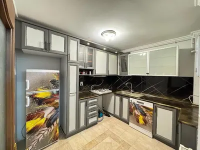 a kitchen with white cabinets and black counter tops at شقه الأحلام بمنطقة شيشلى ثلاث غرف وصالون in Istanbul