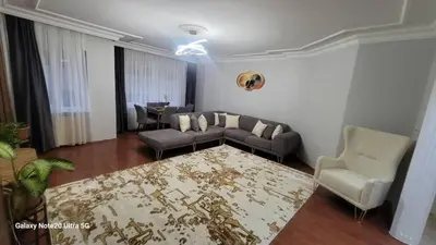 a living room with a couch and a table at شقه الأحلام بمنطقة شيشلى ثلاث غرف وصالون in Istanbul