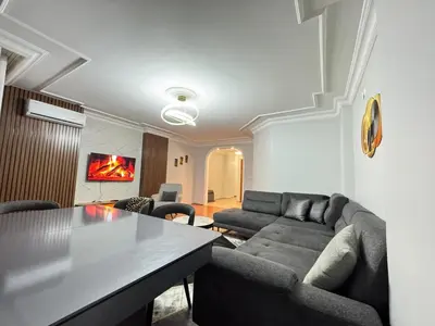 a living room with a couch and a table at Luxurious apartment in Sisli area, three rooms and a living room in Istanbul