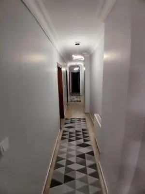 a hallway with a checkered floor in a building at Luxurious apartment in Sisli area, three rooms and a living room in Istanbul