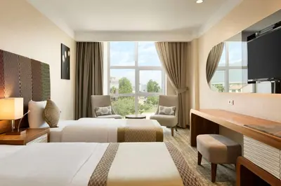a hotel room with two beds and a large window at Ramada by Wyndham Gemli̇k in Gemlik