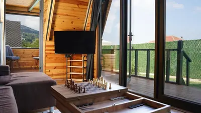 a living room with a chess board on a table at Hilltop Bungalov Sapanca 1 in Sapanca