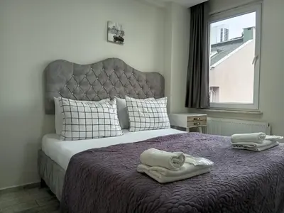 a bedroom with a bed with towels on it at Nexus By Taksim Hotel in Istanbul