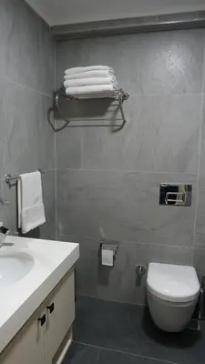 a bathroom with a white toilet and a sink at Karadeniz Hotel Çorlu in Corlu