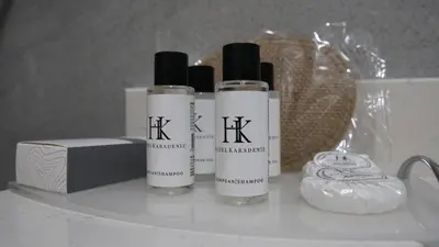 a group of three shampoo bottles sitting on a shelf at Karadeniz Hotel Çorlu in Corlu