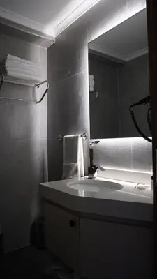 a bathroom with a sink and a mirror at Karadeniz Hotel Çorlu in Corlu