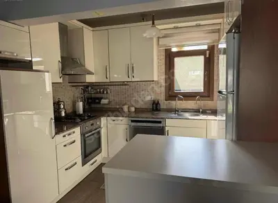 a kitchen with white cabinets and a white counter top at Villa Luna Sapanca in Sakarya