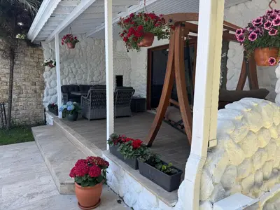 a porch with potted plants and flowers on it at Villa Luna Sapanca in Sakarya