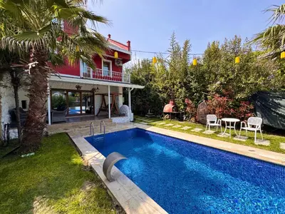 a swimming pool in front of a house at Villa Luna Sapanca in Sakarya