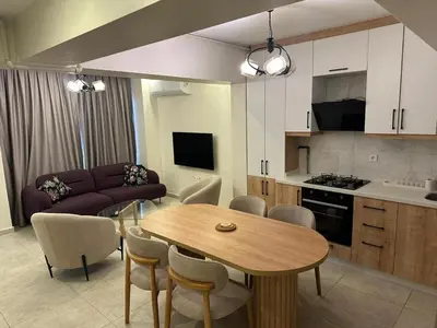 a kitchen and living room with a table and a couch at Modern 2Bedroom Apt in Şişli in Istanbul