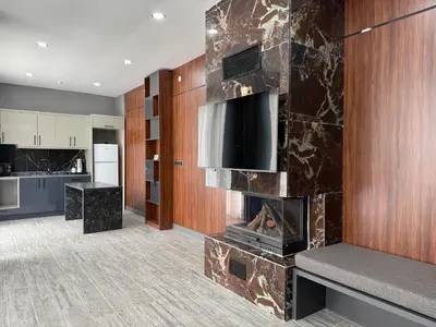 a kitchen with a fireplace in the middle of a room at Hilloria Tatil Köyü in Sapanca