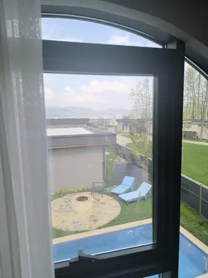 a window with a view of a patio with a chair at Hilloria Tatil Köyü in Sapanca