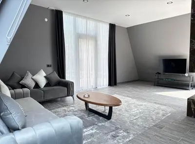 a living room with a couch and a coffee table at Hilloria Tatil Köyü in Sapanca