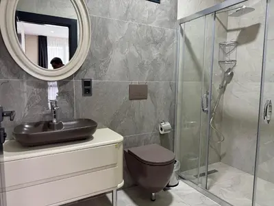 a bathroom with a sink and a glass shower at Hilloria Tatil Köyü in Sapanca