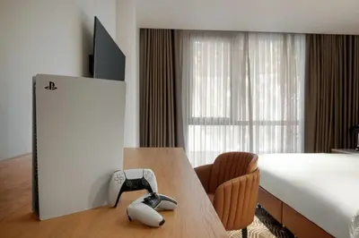 a hotel room with a bed and a phone on a table at Tryp by Wyndham Istanbul Beyoglu in Istanbul
