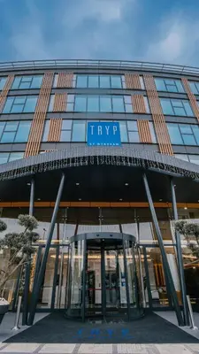 a large building with a sign on the front of it at Tryp by Wyndham Istanbul Beyoglu in Istanbul