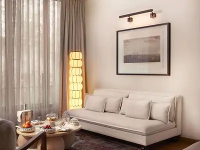 a living room with a couch and a table at Aliée Istanbul - A Paris Society Collection Hotel in Istanbul