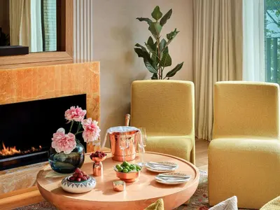 a living room with a coffee table and a fireplace at Aliée Istanbul - A Paris Society Collection Hotel in Istanbul