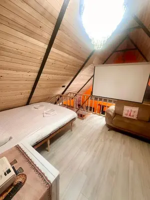 a attic room with a bed and a screen at Bigados Otel & Bungalov in Silivri