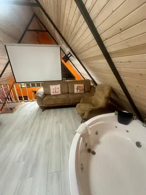 a living room with a couch and a white tub at Bigados Otel & Bungalov in Silivri