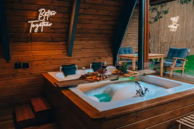 a jacuzzi tub in a room with a sign at Maya Sapanca Bungalow in Sapanca