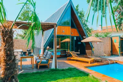 a house with a swimming pool next to a house at Maya Sapanca Bungalow in Sapanca