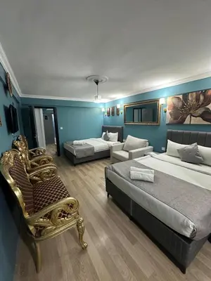 a large room with two beds and a couch at Ada Apart Otel in Istanbul