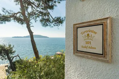a sign on the side of a building next to the water at Palais Büyükada in Adalar