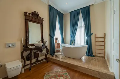 a bathroom with a tub and a sink and a mirror at Palais Büyükada in Adalar
