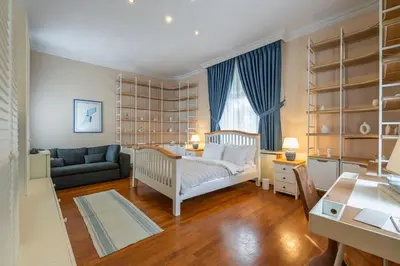a bedroom with a crib and a living room at Palais Büyükada in Adalar