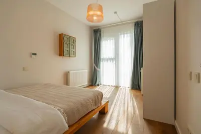 a bedroom with a bed and a large window at Palais Büyükada in Adalar
