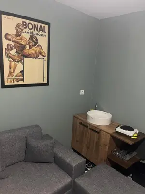 a living room with a couch and a poster on the wall at Murat bey konağı in Istanbul