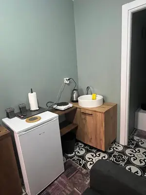 a bathroom with a sink and a desk with a sink at Murat bey konağı in Istanbul
