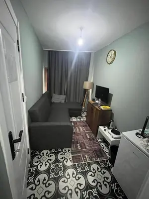 a small living room with a couch and a clock at Murat bey konağı in Istanbul