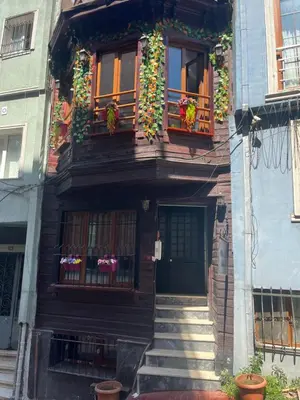 a building with flower boxes and a door and stairs at Murat bey konağı in Istanbul