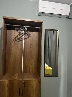 a wooden cabinet in a room with a mirror at Murat bey konağı in Istanbul
