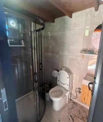 a small bathroom with a toilet and a shower at Flamingo Sapanca in Sapanca