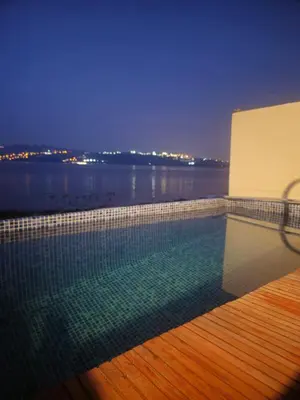 a swimming pool on a building with a view of the water at Flamingo Sapanca in Sapanca