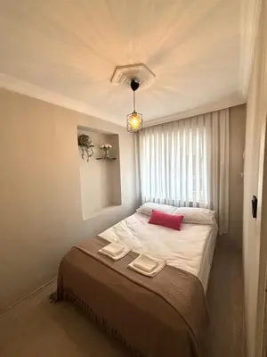 a bedroom with a bed with two towels on it at Pink House - Central Location by Seashore, Fiber Internet in Istanbul