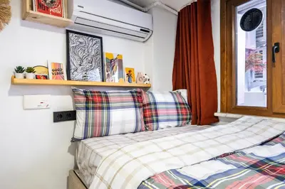 a small bedroom with a bed and a window at Galata Hidden Apartments in Istanbul
