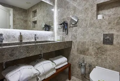 a bathroom with a sink and a mirror and towels at Renata Boutique Hotel Sisli in Istanbul