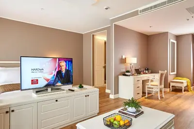 a living room with a flat screen tv on a white cabinet at Renata Boutique Hotel Sisli in Istanbul