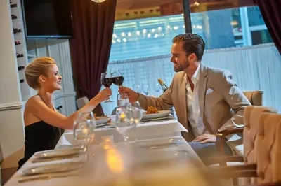 a man and woman sitting at a table drinking wine at Renata Boutique Hotel Sisli in Istanbul