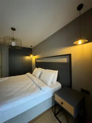 a bedroom with a large white bed and a table at Gezgin Residence in Istanbul