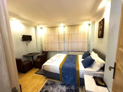 a bedroom with a bed and a living room at Blue Star Apartments Old City Center in Istanbul