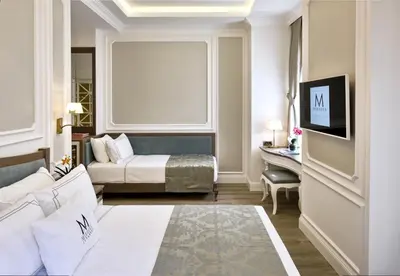 a hotel room with a bed and a desk at Mirrors Hotel İstanbul Taksim City Center in Istanbul