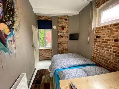 a bedroom with a bed and a brick wall at Hendec 7 Apartments Near Galataport in Istanbul
