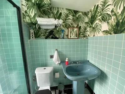 a blue bathroom with a sink and a toilet at Hendec 7 Apartments Near Galataport in Istanbul