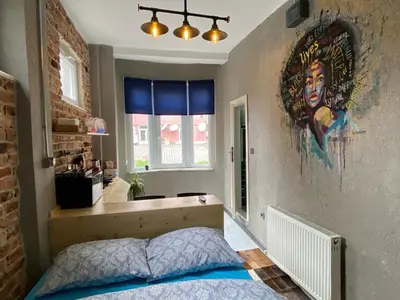 a bedroom with a bed and a mural on the wall at Hendec 7 Apartments Near Galataport in Istanbul